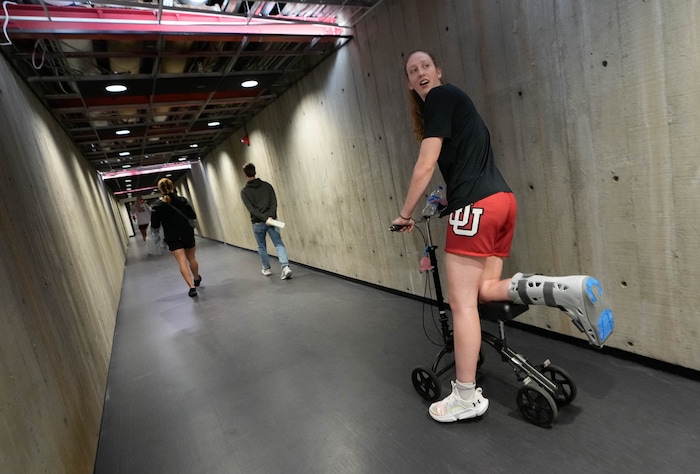 (Francisco Kjolseth  |  The Salt Lake Tribune) Utah basketball guard Gianna Kneepkens traverses the tunnel that connects the weight room to the practice court with the assistance of a leg scooter on Wednesday, Jan. 24, 2024. Kneepkens sustained a season-ending foot injury, breaking multiple bones in her foot. 