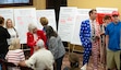 (Francisco Kjolseth  | The Salt Lake Tribune) People gather around excerpts from books removed from public schools following a news conference at the Utah Capitol to discuss why removing 13 books statewide from public schools is "a bright day" for Utah on Thursday Aug. 29, 2024.