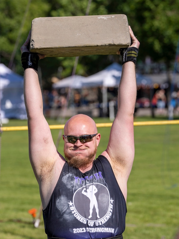 (Rick Egan | The Salt Lake Tribune)  Daniel Moote competes in the Stone Press event in the Utah Stones of Strength Strongman competition at the Utah Scottish Festival, at the Utah State Fairpark, on Friday, June 16, 2023.
