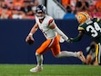 Denver Broncos quarterback Zach Wilson (4) and Green Bay Packers cornerback Kalen King (34) in an NFL preseason football game Sunday, Aug. 18, 2024, in Denver. (AP Photo/David Zalubowski)