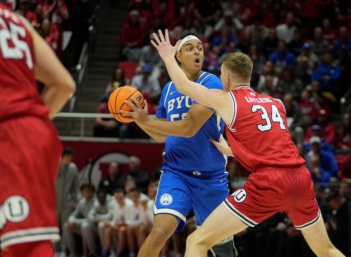 (Bethany Baker  |  The Salt Lake Tribune) Brigham Young Cougars center Aly Khalifa (50) looks to pass the ball as Utah Utes center Lawson Lovering (34) defends at the Jon M. Huntsman Center in Salt Lake City on Saturday, Dec. 9, 2023.