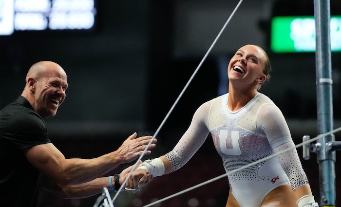 (Francisco Kjolseth  |  The Salt Lake Tribune) Maile O’Keefe celebrates her performance on the bars with assistant coach Jimmy Pratt during the Pac-12 Gymnastics Championships, at the Maverik Center in West Valley City on Saturday, March 23, 2024.