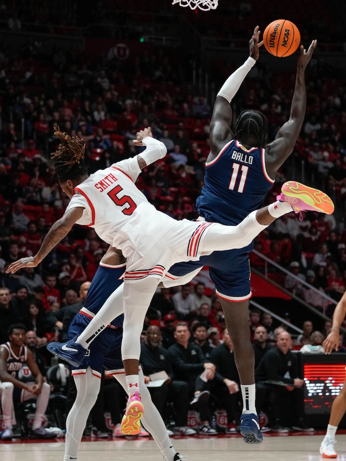 (Francisco Kjolseth  |  The Salt Lake Tribune) Utah Utes guard Deivon Smith (5) falls to the floor as Arizona Wildcats center Oumar Ballo (11) recovers a ball in PAC-12 basketball action between the Utah Utes and the Arizona Wildcats at the Jon M. Huntsman Center, on Thursday, Feb. 8, 2024.