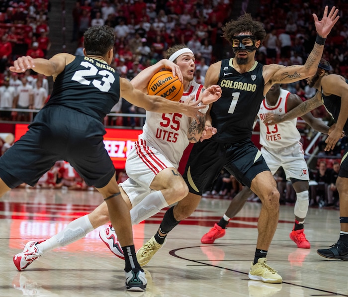 (Rick Egan | The Salt Lake Tribune) Utah Utes guard Gabe Madsen (55) takes the ball to the hoop, as Colorado Buffaloes forward Tristan da Silva (23) and Buffaloe guard J'Vonne Hadley (1) defend, in PAC-12 basketball action between the Utah Utes and the Colorado Buffaloes a the Jon M. Huntsman Center, on Saturday, Feb. 3, 2024.
