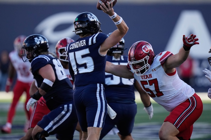 (Francisco Kjolseth  | The Salt Lake Tribune) Utah State Aggies quarterback Jacob Conover (15) is pressured by Utah Utes defensive tackle Keanu Tanuvasa (57) as Utah State hosts the University of Utah during the second half of an NCAA college football game Saturday, Sept. 14, 2024, in Logan, Utah.