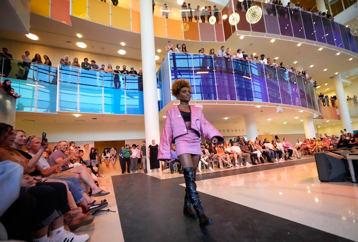 (Francisco Kjolseth | The Salt Lake Tribune) Patience Turay showcases the work of The Sew Sew as hip-hop artist Lady Infinity fills the lobby of the Eccles Theater with sound on Friday, July 21, 2023. The free show that jam-packed the lobby and upper-level balconies drew an outside crowd as models briefly walked outside, carried by the vocals. 