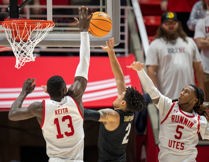 (Rick Egan | The Salt Lake Tribune) Utah Utes center Keba Keita (13) blocks a shot by Colorado Buffaloes guard KJ Simpson (2), in PAC-12 basketball action between the Utah Utes and the Colorado Buffaloes a the Jon M. Huntsman Center, on Saturday, Feb. 3, 2024.
