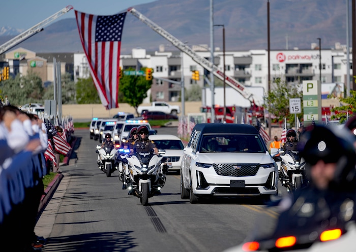 (Francisco Kjolseth  |  The Salt Lake Tribune) Law enforcement arrives escorting the hearse for Santaquin police Sgt. Bill Hooser’s funeral at the UCCU Center at Utah Valley University in Orem on Monday, May 13, 2024.