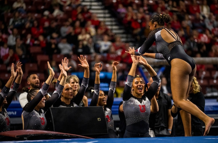 (Rick Egan | The Salt Lake Tribune)  Red Rocks congratulate Jaedyn Rucker after her floor routine for Utah, in Gymnastics actin between Utah, LSU, Oklahoma and UCLA at the Maverik Center, on Saturday, Jan. 13, 2024.
