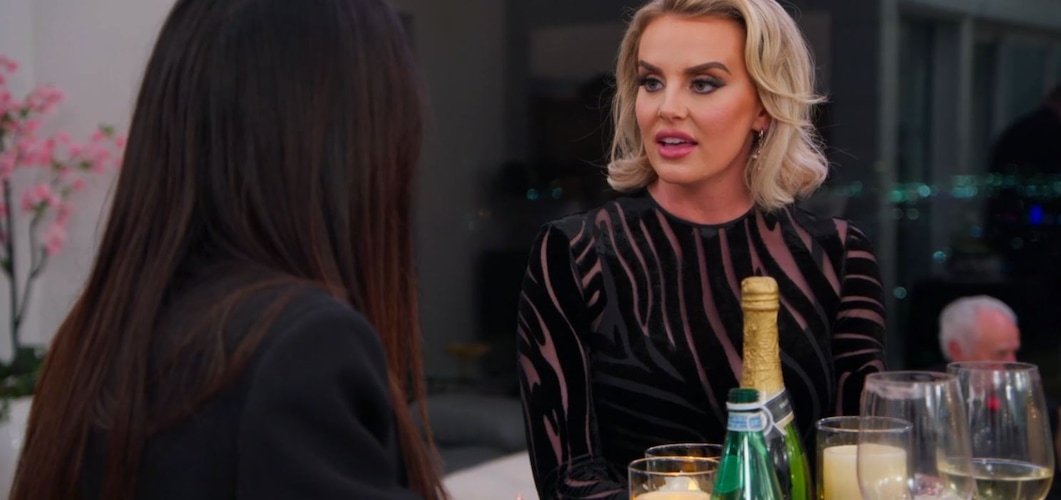 (Bravo) Whitney Rose talks with Lisa Barlow at Angie Katsanevas' and Shawn Trujillo's 25th anniversary party, in an episode of "The Real Housewives of Salt Lake City."