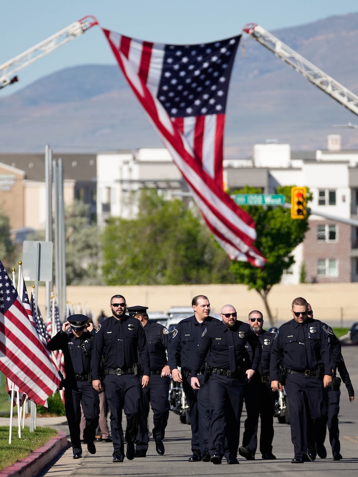 (Francisco Kjolseth  |  The Salt Lake Tribune) Law enforecement arrives for funeral services for Santaquin police Sgt. Bill Hooser at the UCCU Center at Utah Valley University on Monday, May 13, 2024.