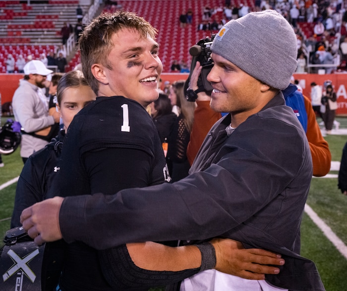 (Rick Egan | The Salt Lake Tribune) Corner Canyon QB Isaac Wilson (1) gets. Hug from his brother Zach, as they celebrate the Chargers 6A State championship win over the Skyridge Falcons, at Rice-Eccles Stadium, on Friday, Nov. 17, 2023.