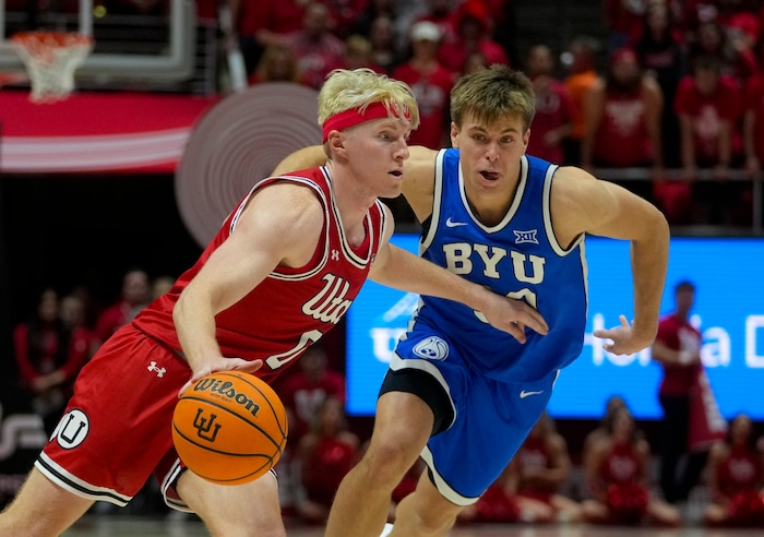 (Bethany Baker  |  The Salt Lake Tribune) Utah Utes guard Hunter Erickson (0) drives to the basket as Brigham Young Cougars guard Dallin Hall (30) defends at the Jon M. Huntsman Center in Salt Lake City on Saturday, Dec. 9, 2023.