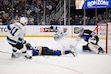 Utah Hockey Club's Dylan Guenther (11) and Utah Hockey Club's Vladislav Kolyachonok (52), back center, watch on as St. Louis Blues' Joel Hofer (30) and St. Louis Blues' Colton Parayko (55) defend the net during the third period of an NHL hockey game Thursday, Nov. 7, 2024, in St. Louis. (AP Photo/Connor Hamilton)