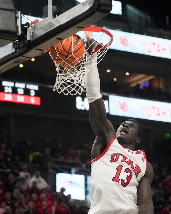 (Bethany Baker  |  The Salt Lake Tribune) Utah Utes center Keba Keita (13) slam dunks the ball against the Hawaii Warriors at the Delta Center in Salt Lake City on Thursday, Nov. 30, 2023.