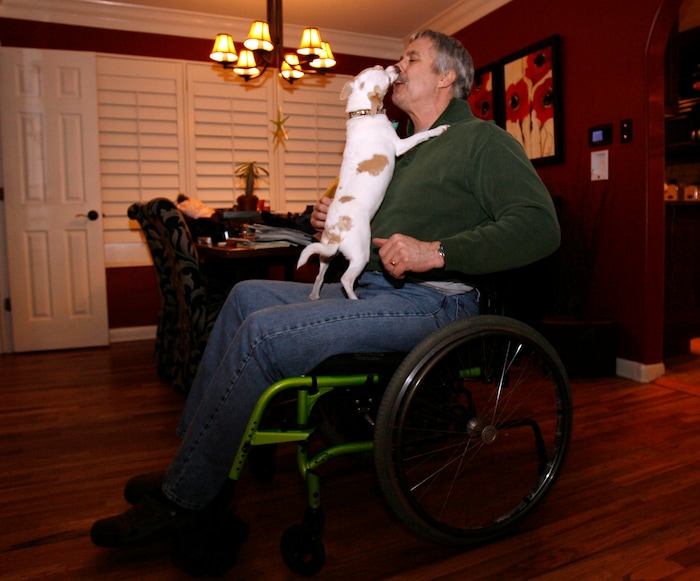 (Steve Griffin | The Salt Lake Tribune) Stacy Hanson gets a welcome home kiss from his dog Popeye following work Wednesday, Feb. 11, 2009. Stacy was shot and injured in the 2007 Trolley Square shooting.