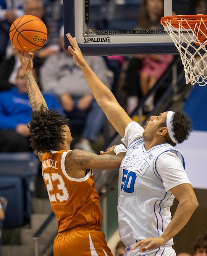 (Rick Egan | The Salt Lake Tribune) Texas Longhorns forward Dillon Mitchell (23) shoots over Brigham Young Cougars center Aly Khalifa (50)  in basketball action between the Brigham Young Cougars and the Texas Longhorns, at the Marriott Center, on Saturday, Jan. 27, 2024.
