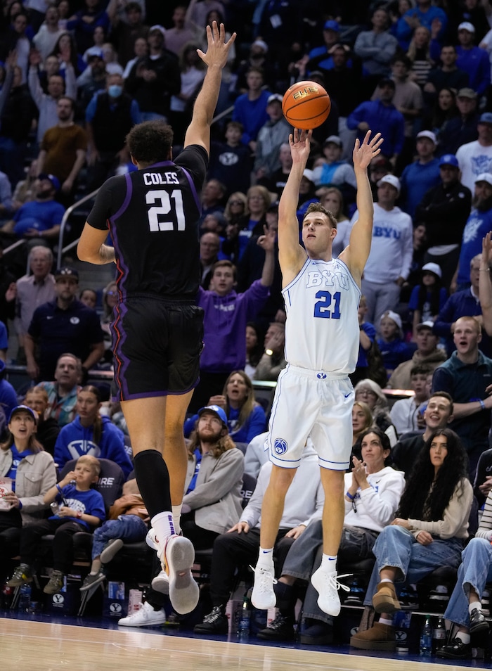 (Francisco Kjolseth  |  The Salt Lake Tribune) Brigham Young Cougars guard Trevin Knell (21) sinks a three point shot over TCU Horned Frogs forward JaKobe Coles (21) during an NCAA college basketball game against TCU Saturday, March 2, 2024, in Provo, Utah.