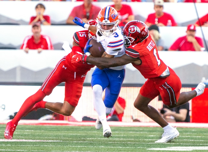 (Rick Egan | The Salt Lake Tribune) 
Utah Utes cornerback Tao Johnson (15) and Utah Utes cornerback Miles Battle (1) try to stop Florida Gators wide receiver Eugene Wilson (3), in football acton between the Utah Utes and the Florida Gators, at Rice-Eccles Stadium, on Thursday, Aug. 31, 2023.
