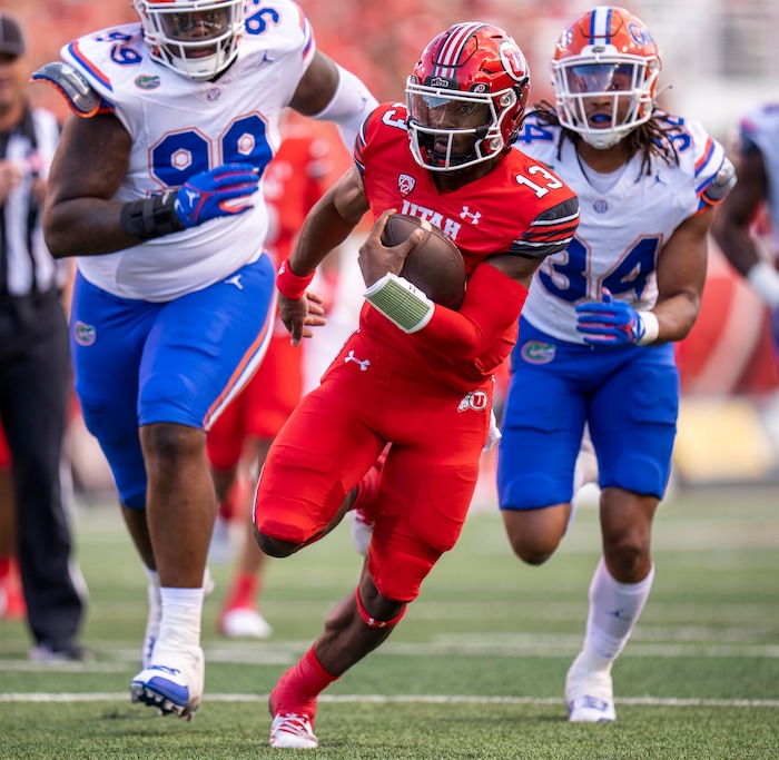 (Rick Egan | The Salt Lake Tribune) Utah Utes quarterback Nate Johnson (13) runs for a touchdown, in football action between the Utah Utes and the Florida Gators at Rice-Eccles Stadium on Thursday, Aug. 31, 2023.