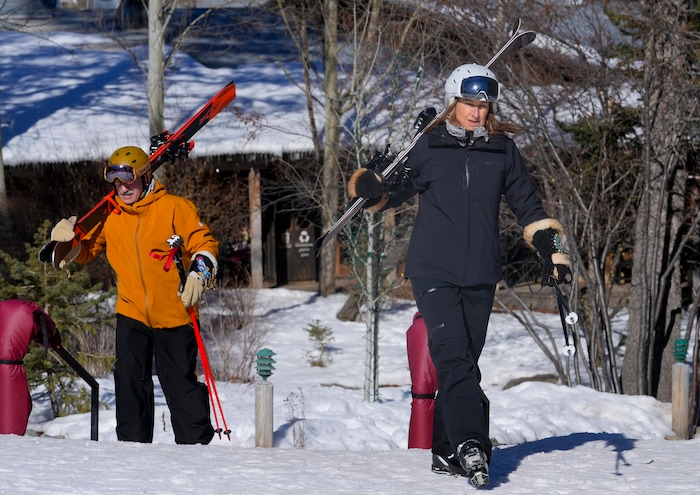 (Bethany Baker  |  The Salt Lake Tribune) Jackie Freiberg, right, and Kevin Freiberg carry their skiis to the lift at Sundance Resort near Provo on Thursday, Dec. 14, 2023.