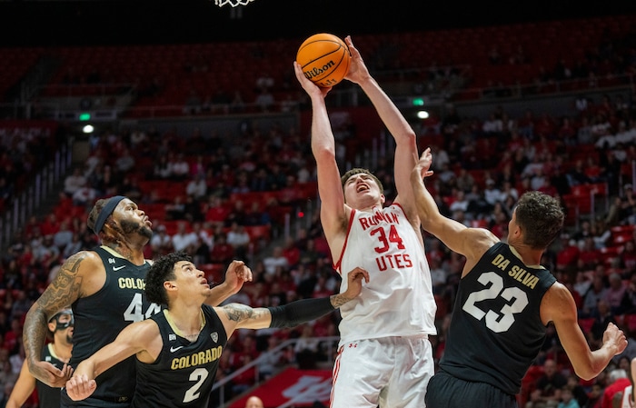 (Rick Egan | The Salt Lake Tribune) Utah Utes center Lawson Lovering (34) shoots as three Colorado Buffalo defenders look on, in PAC-12 basketball action between the Utah Utes and the Colorado Buffaloes, at the Jon M. Huntsman Center, on Saturday, Feb. 3, 2024.
