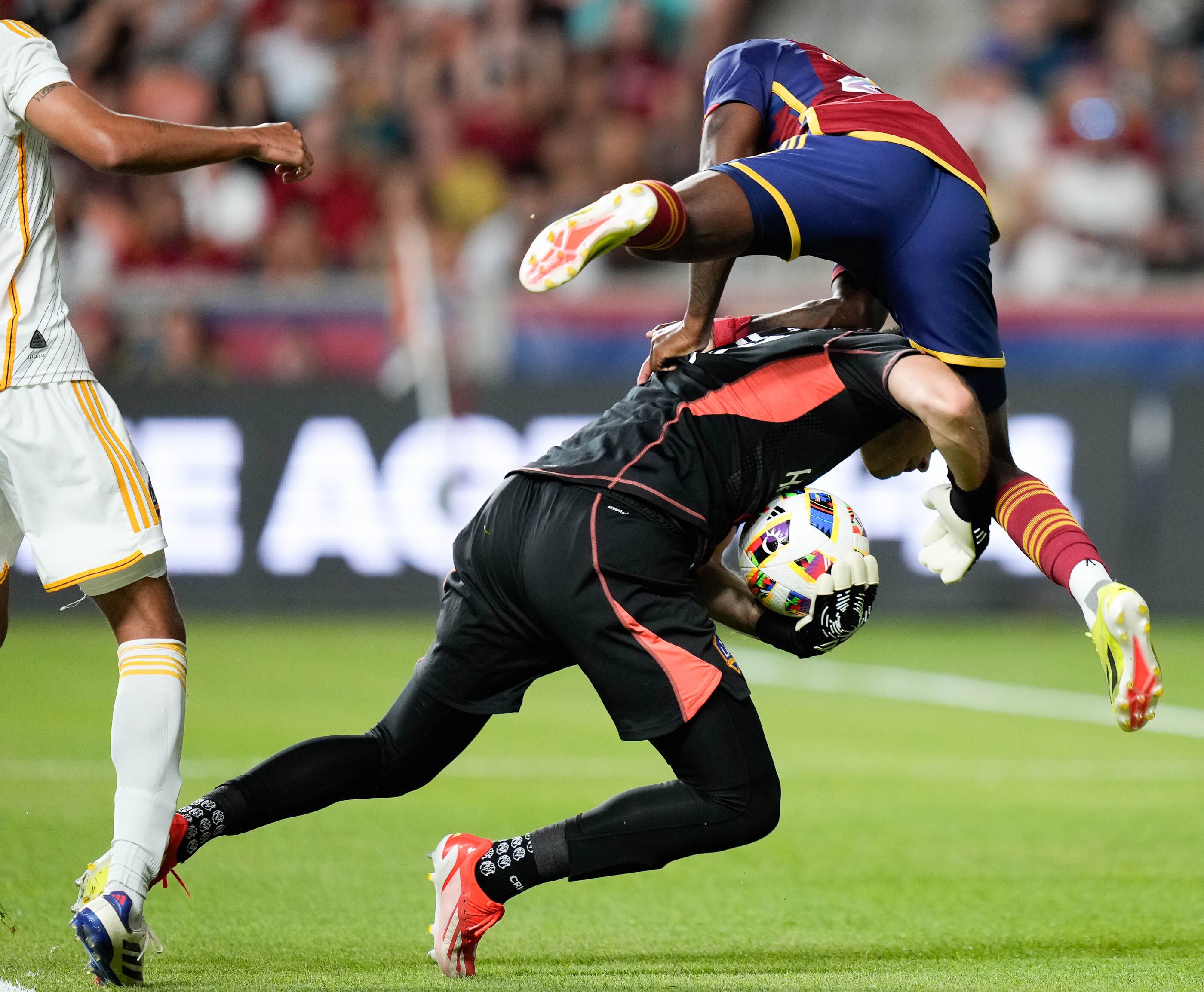 (Francisco Kjolseth | The Salt Lake Tribune) Real Salt Lake midfielder Anderson Julio (29) collides with Los Angeles Galaxy goalkeeper John McCarthy (77) on a drive during an MLS soccer match against LA Galaxy on Saturday, June 22, 2024, in Sandy Utah.