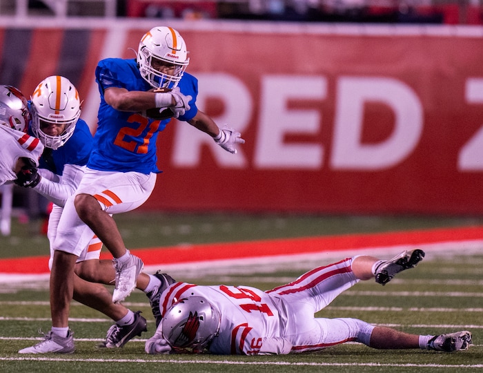 (Rick Egan | The Salt Lake Tribune)   Tru To'a runs for the Thunderbirds, as Britton Tidwell defends for Bountiful , in 5A State playoff action between the Timpview Thunderbirds and the Bountiful Redhawks, at Rice-Eccles Stadium, on Friday, Nov. 17, 2023.
