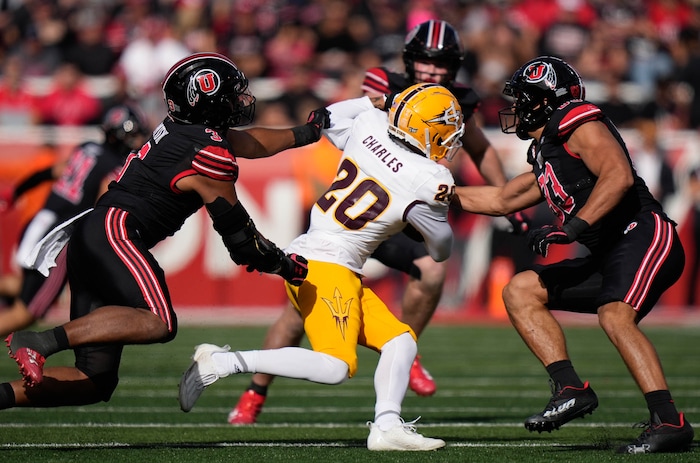 (Francisco Kjolseth  |  The Salt Lake Tribune) Arizona State Sun Devils wide receiver Shawn Charles (20) is stopped by Utah Utes linebacker Levani Damuni (3) and Utah Utes defensive end Jonah Elliss (83) as the Utah Utes host the Arizona State Sun Devils in NCAA football in Salt Lake City on Saturday, Nov. 4, 2023.