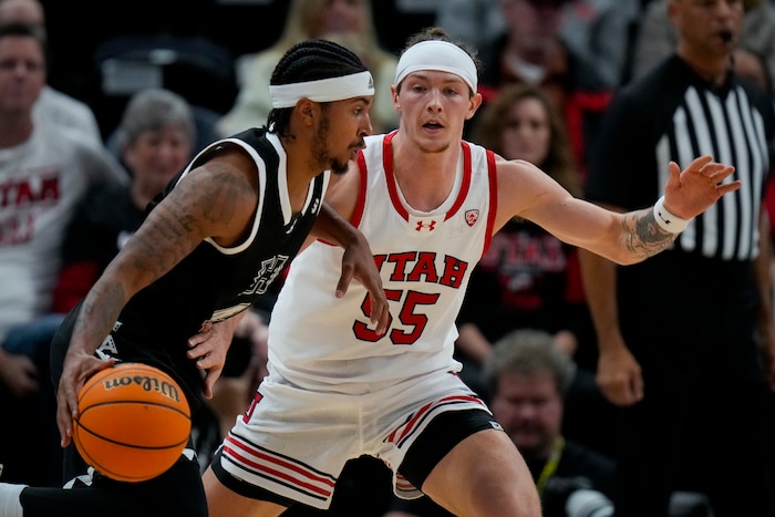 (Bethany Baker  |  The Salt Lake Tribune) Hawaii Warriors guard Noel Coleman (4) moves the ball as Utah Utes guard Gabe Madsen (55) defends at the Delta Center in Salt Lake City on Thursday, Nov. 30, 2023.
