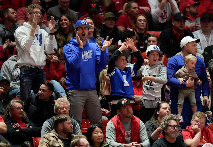 (Bethany Baker  |  The Salt Lake Tribune) Brigham Young Cougars fans cheer during the game against the Utah Utes at the Jon M. Huntsman Center in Salt Lake City on Saturday, Dec. 9, 2023.