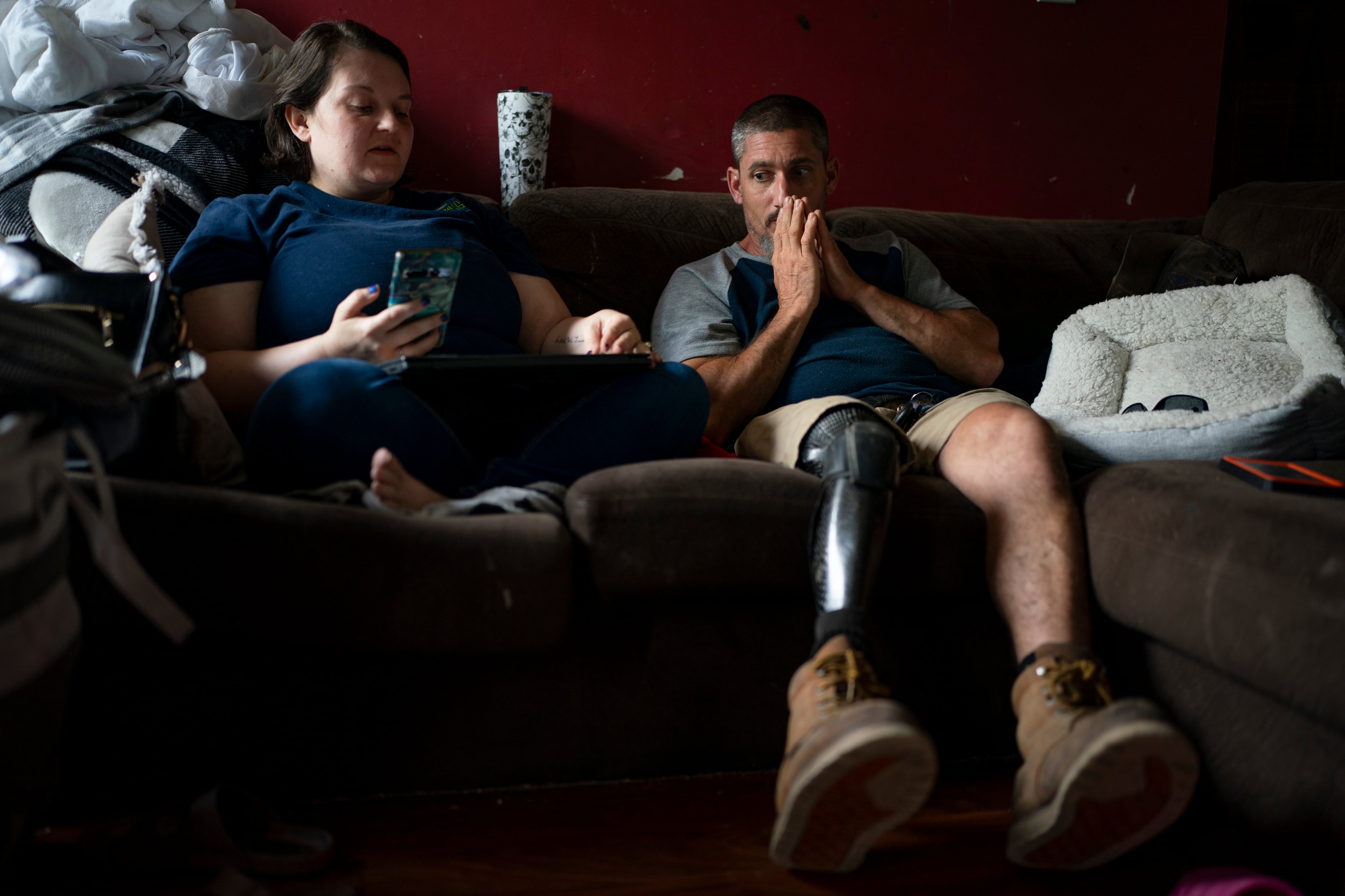 (Denny Simmons | The Tennessean) Lelia and Scott Restivo weigh their options after speaking with an attorney over the phone at their Cedar Hill, Tenn., home Tuesday, July 30, 2024. Restivo, a disabled veteran who served three tours of duty in Iraq and Afghanistan is dealing with post traumatic stress, a traumatic brain injury and a ill-fitting prosthetic leg.