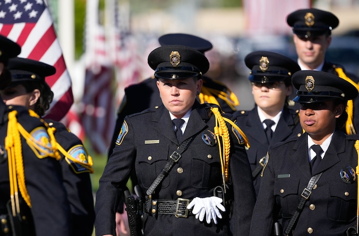 (Francisco Kjolseth  |  The Salt Lake Tribune) Law enforcement arrives for funeral services for Santaquin police Sgt. Bill Hooser at the UCCU Center at Utah Valley University on Monday, May 13, 2024.