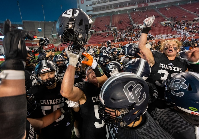 (Rick Egan | The Salt Lake Tribune) The Corner Canyon Chargers celebrate their win over the Skyridge Falcons, for the 6A State championship at Rice-Eccles Stadium, on Friday, Nov. 17, 2023.