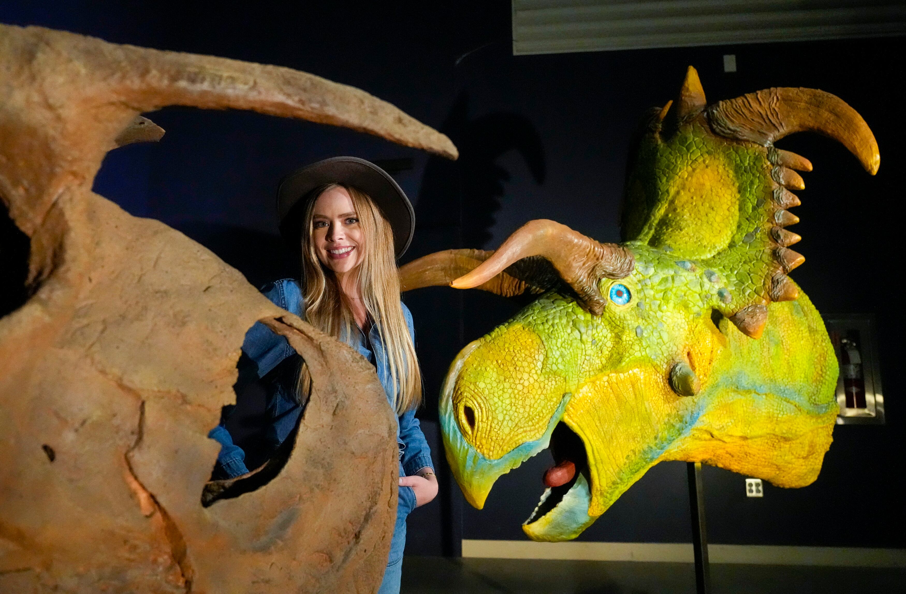 (Bethany Baker | The Salt Lake Tribune) Savhannah Carpenter, a paleontology student with The University of Utah, stands with two models of the new dinosaur being unveiled at the Natural History Museum of Utah at The University of Utah in Salt Lake City on Tuesday, June 18, 2024.