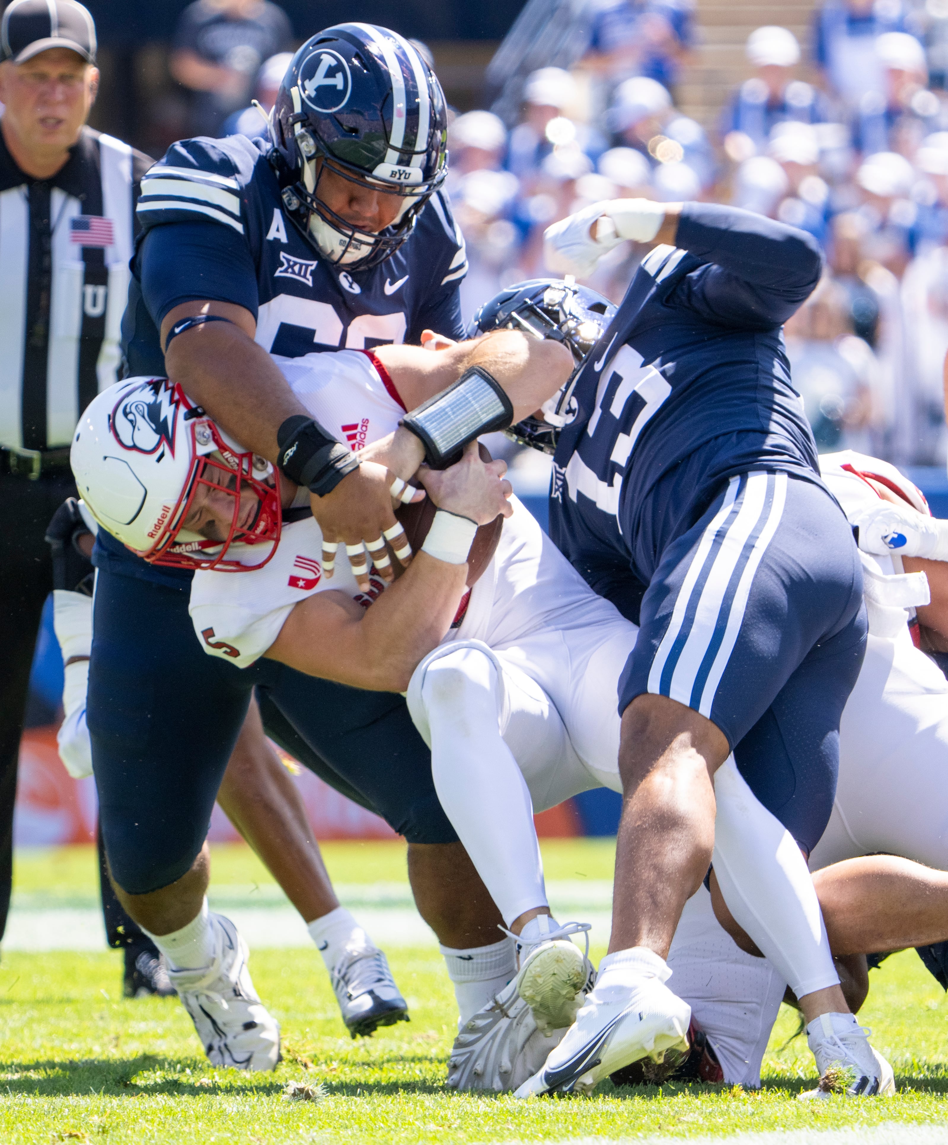 (Rick Egan | The Salt Lake Tribune) Brigham Young Cougars defensive tackle Atunaisa Mahe (62) and defensive end Isaiah Bagnah (13), sack Southern Utah Thunderbirds quarterback Grady Robison (5), in football action between the Southern Utah Thunderbirds and the Brigham Young Cougars, at LaVell Edwards Stadium, on Saturday, Sept. 9, 2023.
