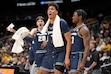 (Charlie Riedel | AP) Utah State players celebrate after a basket during the second half of an NCAA college basketball game against Iowa, Friday, Nov. 22, 2024, in Kansas City, Mo.