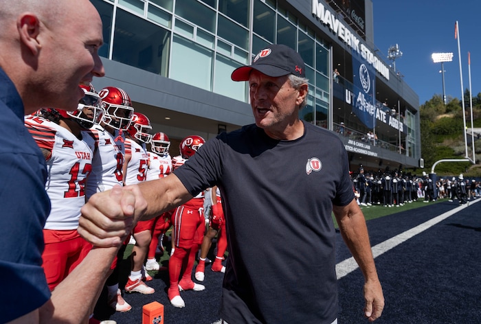 (Francisco Kjolseth  | The Salt Lake Tribune) Utah Gov. Spencer Cox greets University of Utah coach Kyle Whittingham before the start of their game agains Utah State on Saturday, Sept. 14, 2024, in Logan, Utah.