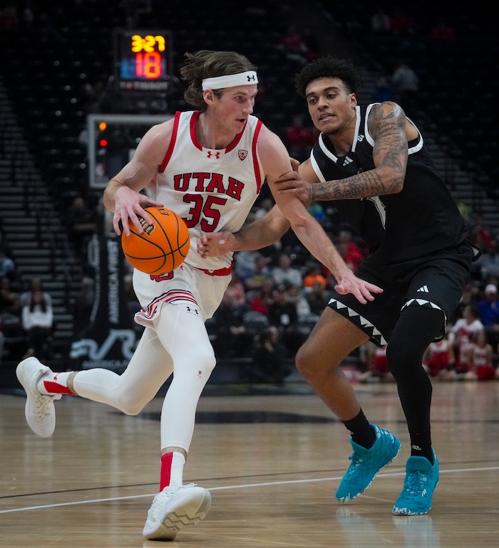 (Bethany Baker  |  The Salt Lake Tribune) Utah Utes center Branden Carlson (35) drives to the basket as Hawaii Warriors forward Justin McKoy (1) tries to steal at the Delta Center in Salt Lake City on Thursday, Nov. 30, 2023.
