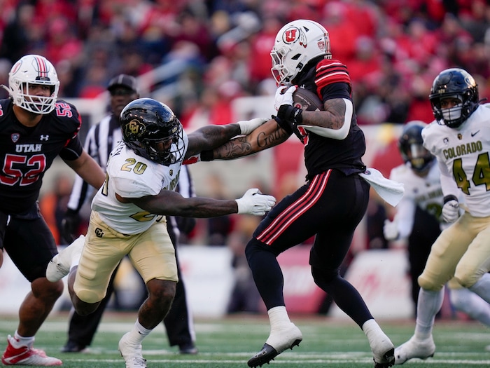 (Bethany Baker  |  The Salt Lake Tribune) Utah Utes running back Ja'Quinden Jackson (3) avoids a tackle from Colorado Buffaloes linebacker LaVonta Bentley (20) at Rice-Eccles Stadium in Salt Lake City on Saturday, Nov. 25, 2023.