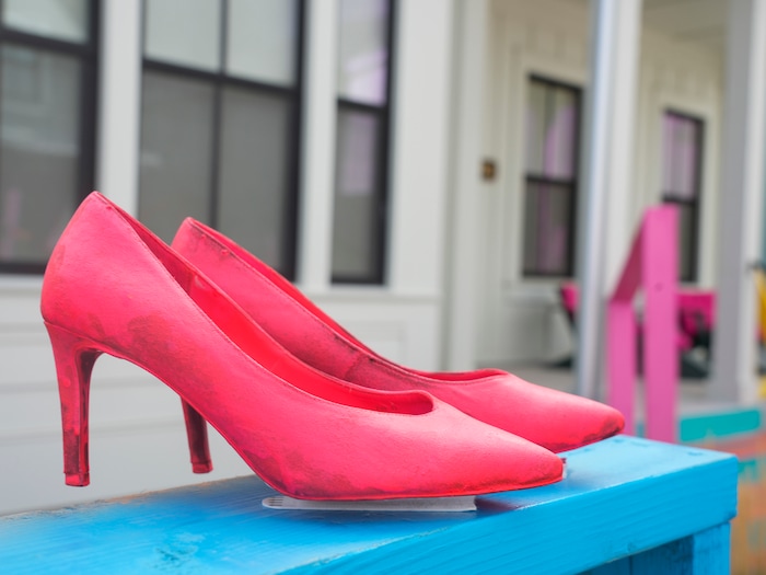 (Bethany Baker  |  The Salt Lake Tribune) A pair of pink high heels sits in front of a house in a section of Daybreak that has collectively created a Barbieland-themed community for Halloween on Wednesday, Oct. 11, 2023.