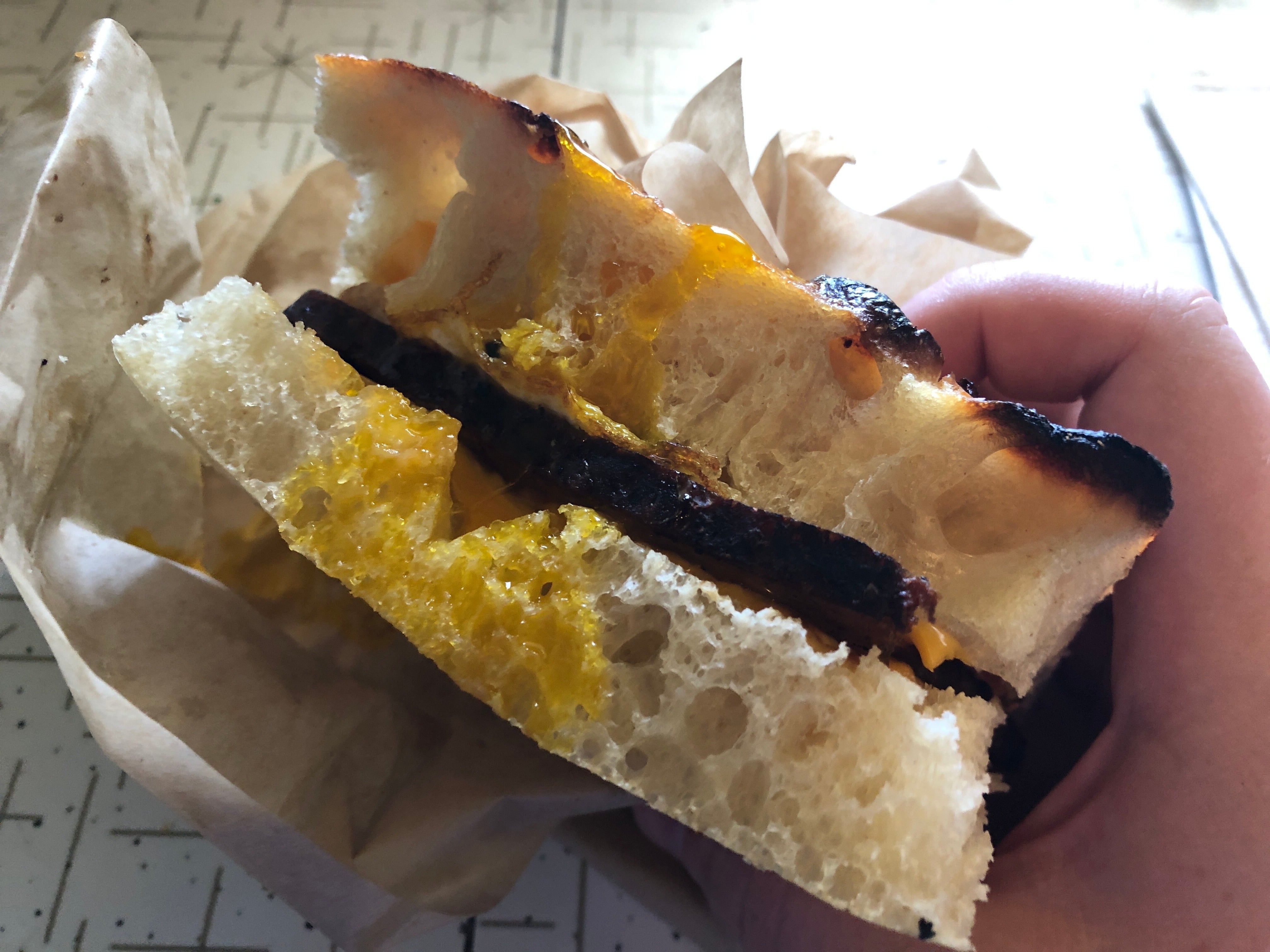 (Kolbie Peterson | The Salt Lake Tribune) A sausage, cheese and egg breakfast sandwich from Central 9th Market is shown on Sunday, June 23, 2024.