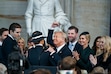 (Kenny Holston | The New York Times) President Donald Trump pumps his fist and is surrounded by his family after he was sworn in by Supreme Court Chief Justice John Roberts during his inauguration ceremony as the 47th president in the Rotunda at the Capitol in Washington on Monday morning, Jan. 20, 2025.