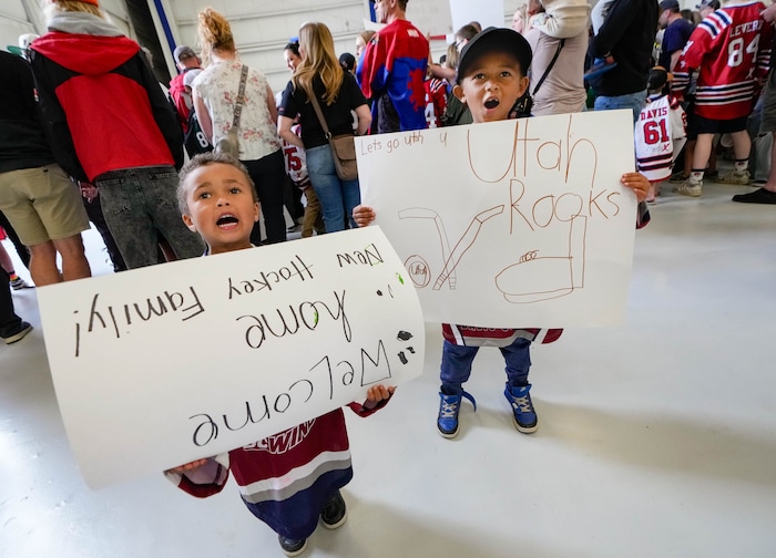 (Francisco Kjolseth  |  The Salt Lake Tribune) Young hockey fans Jordan Mortensen, 4, and his brother Nixon proudly display their posters as they wait for the arrival of the new NHL team at the airport in Salt Lake City on Wednesday, April 24, 2024.