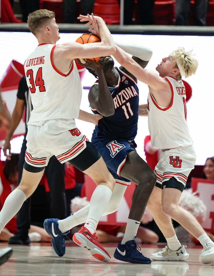 (Francisco Kjolseth  |  The Salt Lake Tribune) Arizona Wildcats center Oumar Ballo (11) gets boxed in by Utah Utes center Lawson Lovering (34) and Utah Utes guard Hunter Erickson (0) in PAC-12 basketball action between the Utah Utes and the Arizona Wildcats at the Jon M. Huntsman Center, on Thursday, Feb. 8, 2024.