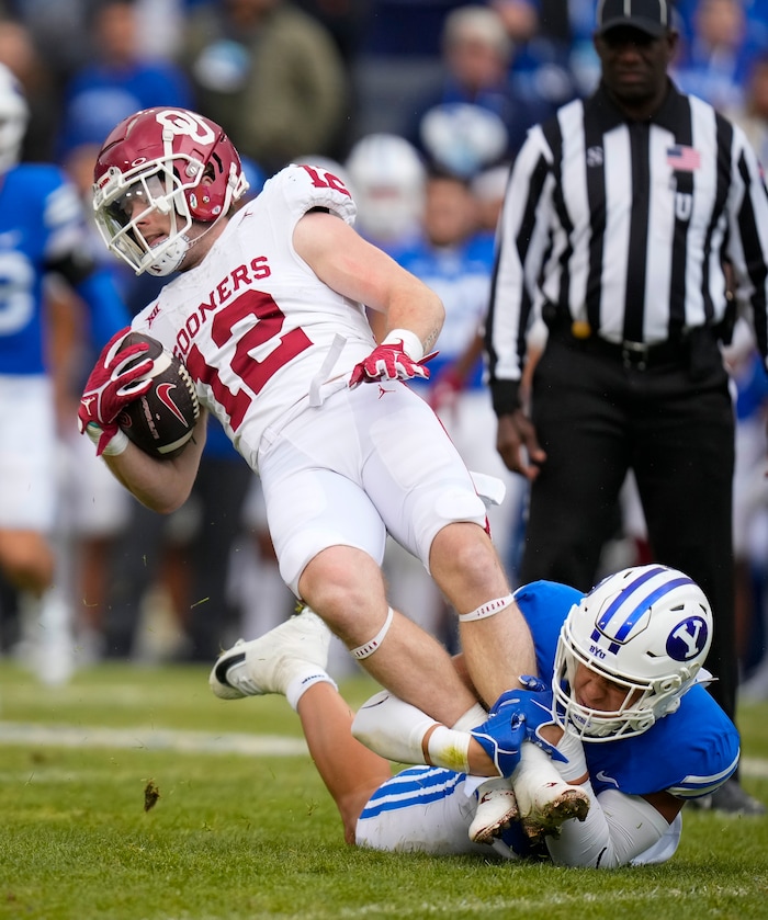 (Bethany Baker  |  The Salt Lake Tribune) Brigham Young Cougars linebacker Chaz Ah You (3) tackles Oklahoma Sooners wide receiver Drake Stoops (12) at LaVell Edwards Stadium in Provo on Saturday, Nov. 18, 2023.