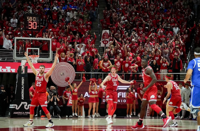 (Bethany Baker  |  The Salt Lake Tribune) Utah Utes fans cheer during the game against the Brigham Young Cougars at the Jon M. Huntsman Center in Salt Lake City on Saturday, Dec. 9, 2023.