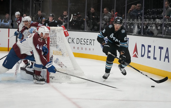 (Bethany Baker  |  The Salt Lake Tribune) Utah Hockey Club center Jack McBain (22) skates behind the goal as Colorado Avalanche defenseman Calvin de Haan (44) defends during the game between the Utah Hockey Club and the Colorado Avalanche at the Delta Center in Salt Lake City on Thursday, Oct. 24, 2024.