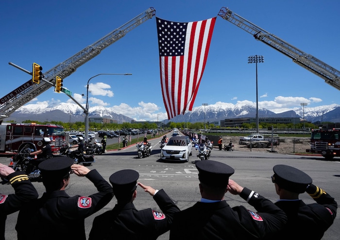 (Francisco Kjolseth  |  The Salt Lake Tribune) Members of the Orem Fire Department salute the hearse containing the body of Santaquin police Sgt. Bill Hooser following ceremonies at the UCCU Center at Utah Valley University in Orem on Monday, May 13, 2024.