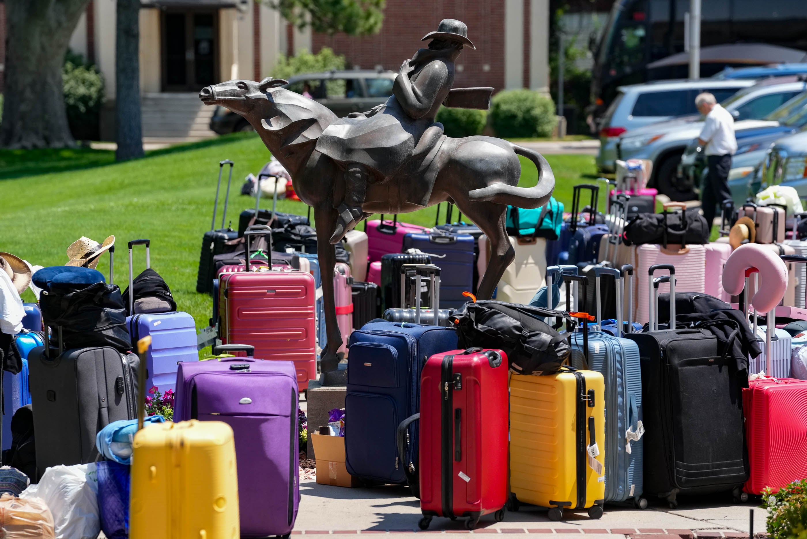 (Francisco Kjolseth | The Salt Lake Tribune) A sea of colorful luggage surrounds the Springville Art Museum on Sunday, July 28, 2024, as folk dancers from around the world unload from buses to meet their host families taking them in for the annual World Folkfest in Springville. 